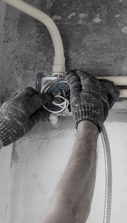 close up of an electricians hands during new construction electrical installation marceline mo